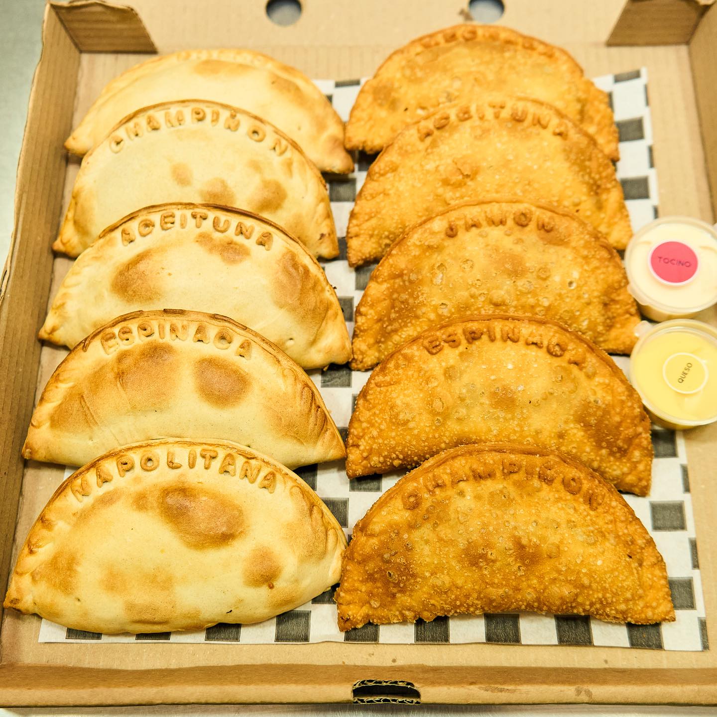 Empanada de carne cortada mostrando su relleno jugoso con carne molida, huevo, aceitunas y pasas